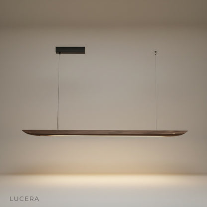 Studio shot of the Fauvist pendant light showing its elongated wooden form against a clean white background