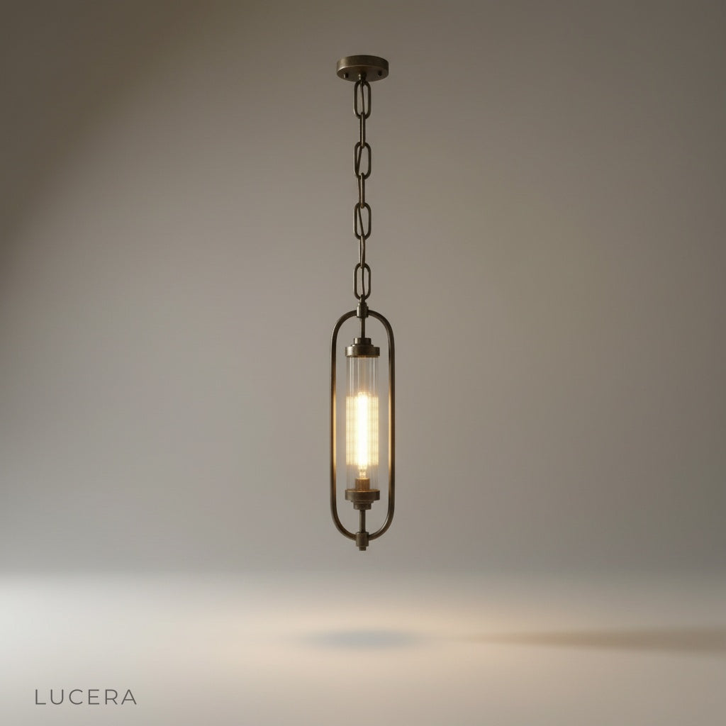 studio shot of Zigzag Lucis pendant lamp with oval brass frame and fluted glass shade