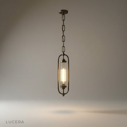 studio shot of Zigzag Lucis pendant lamp with oval brass frame and fluted glass shade