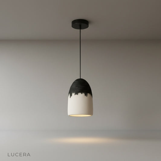 studio shot of white Berceuse pendant lamp with elongated two-tone shade