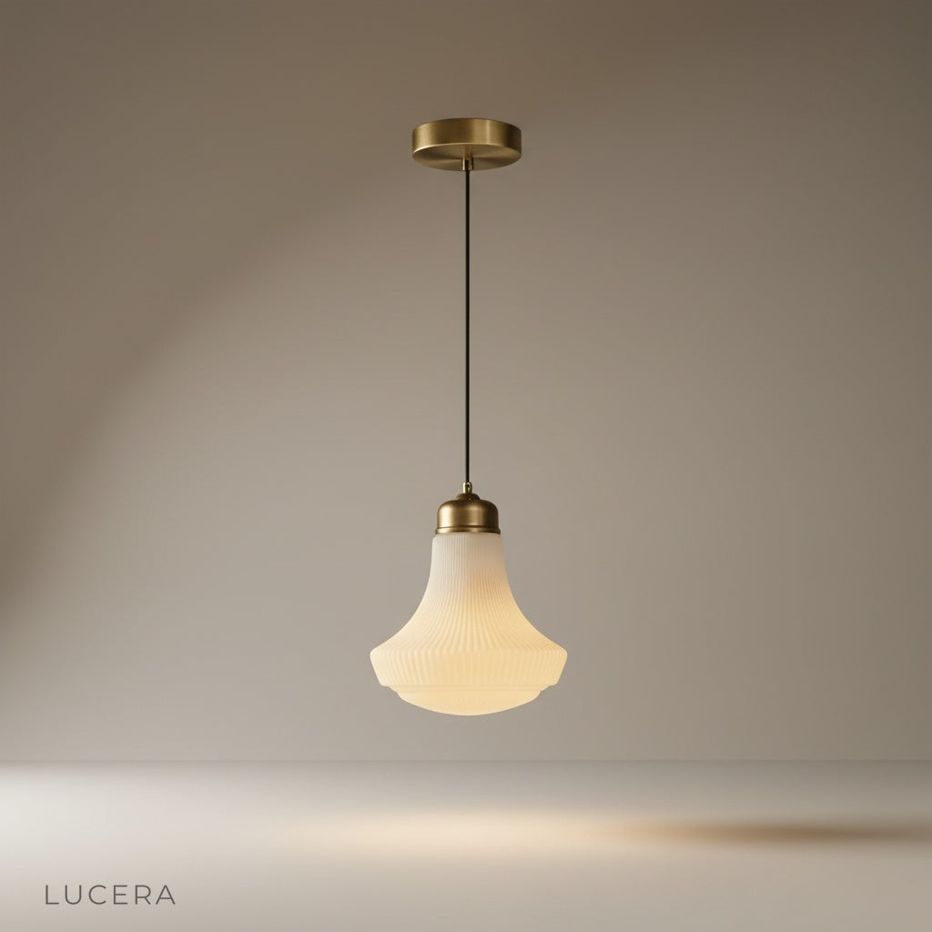 studio shot of brass Chianti pendant light with bell-shaped glass shade on neutral background