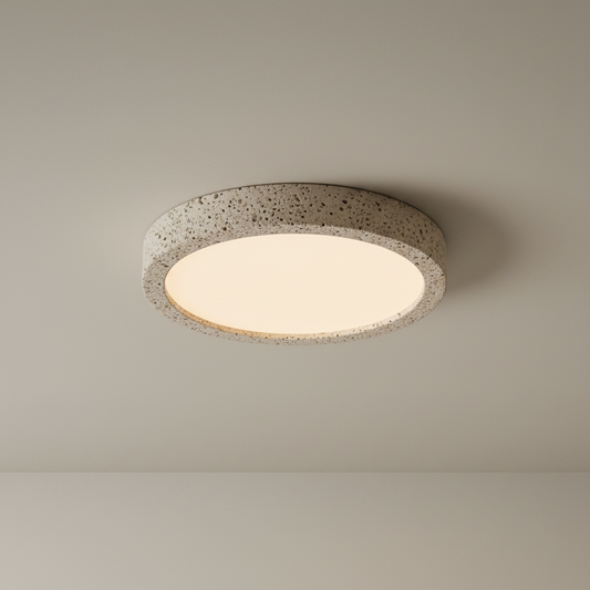 Studio shot of round Icy Ceiling Light with frosted acrylic diffuser and travertine frame