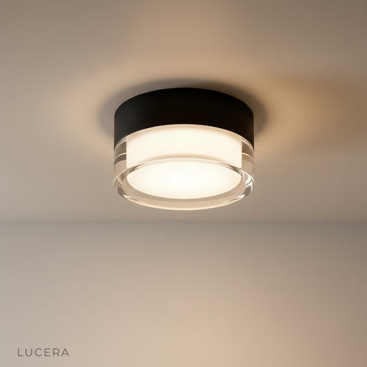 studio shot of round Vulcan downlight with aluminum trim and acrylic lens, front view