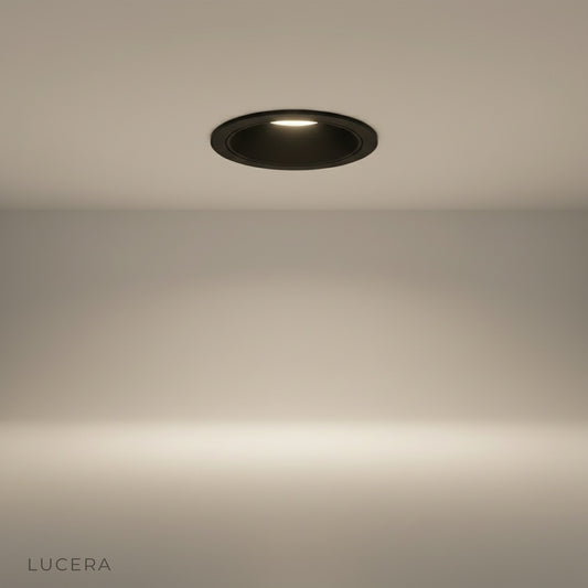 studio shot of a sleek aluminum downlight trim against a clean white background