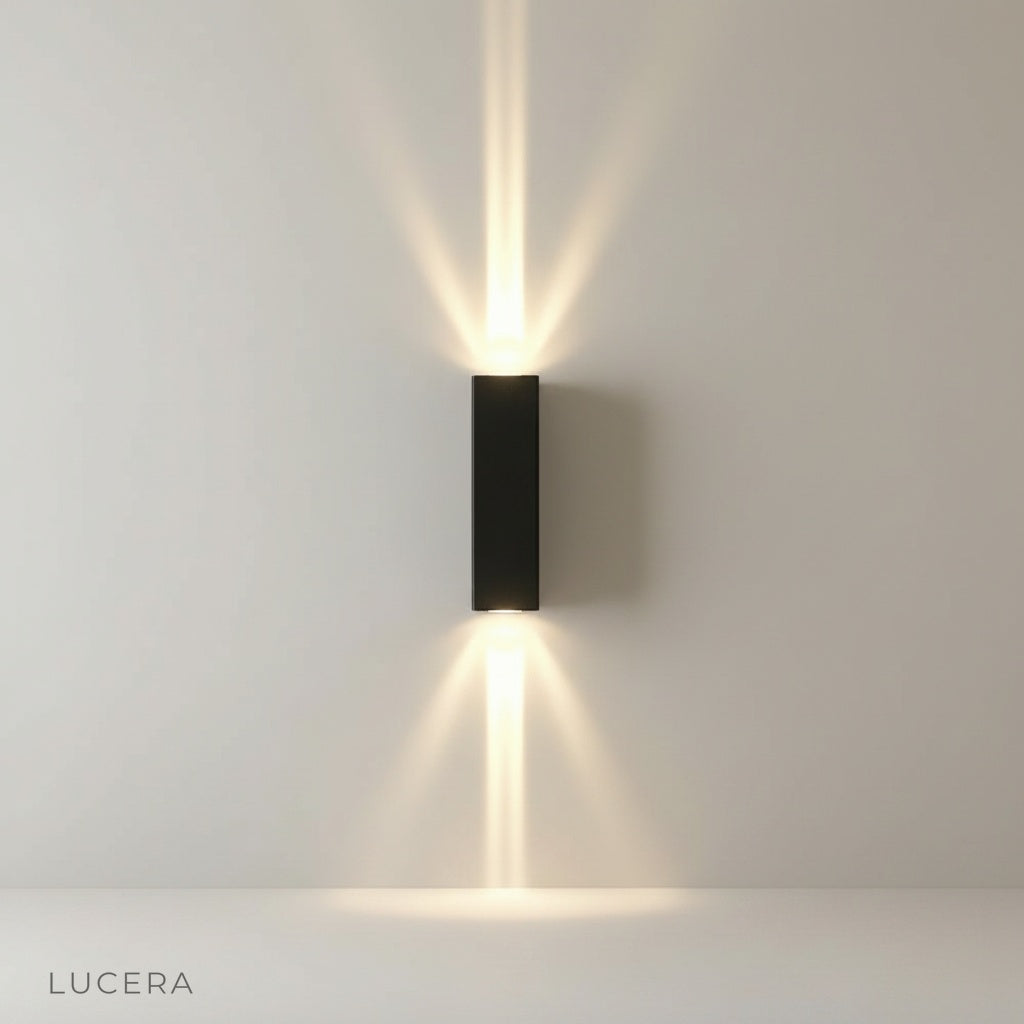 studio shot of gold wall lamp with sleek minimalist curved arm
