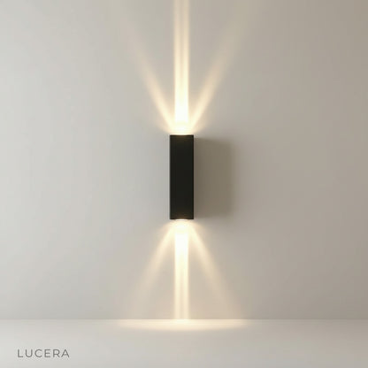 studio shot of gold wall lamp with sleek minimalist curved arm