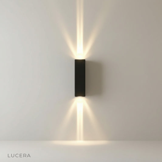 studio shot of gold wall lamp with sleek minimalist curved arm
