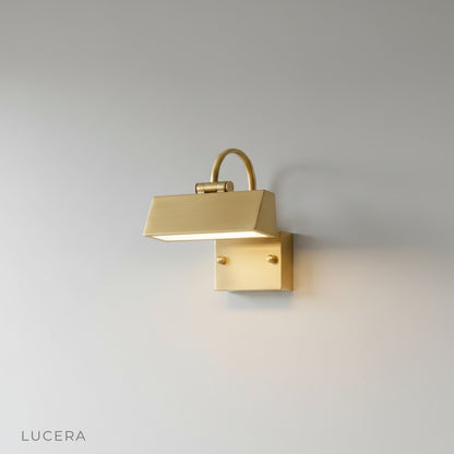 Minimalist black metal Quiete wall lamp mounted on a clean white studio wall