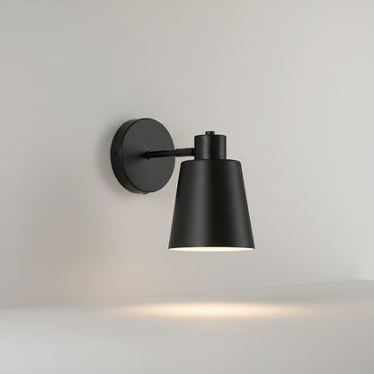 studio shot of conical matte gold wall lamp on clean white background