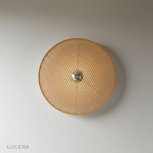 studio shot of Captivate wall lamp with sturdy metal frame and woven rattan shade