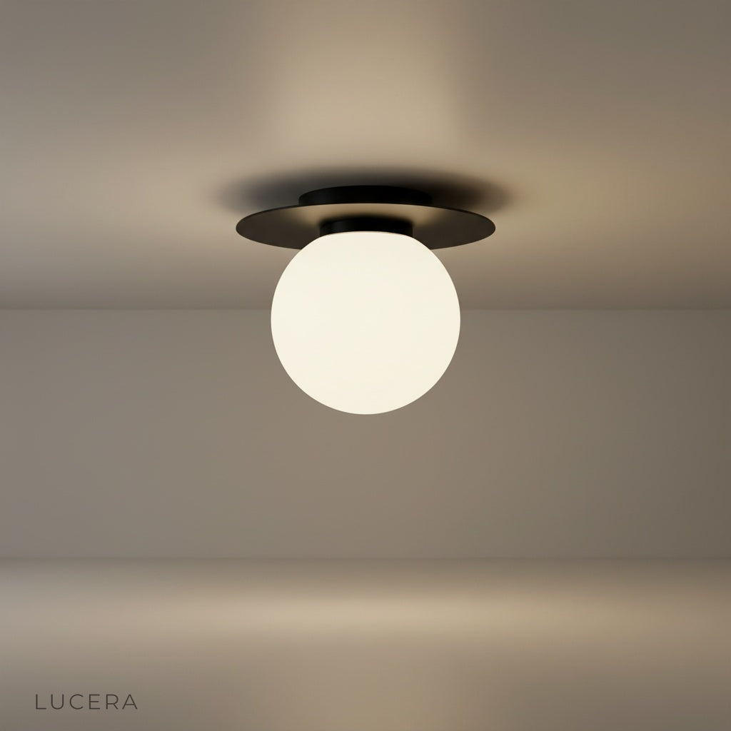 studio shot of gold-plated Bijou ceiling light with clear glass ball on white background