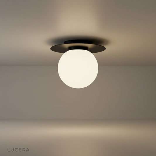 studio shot of gold-plated Bijou ceiling light with clear glass ball on white background