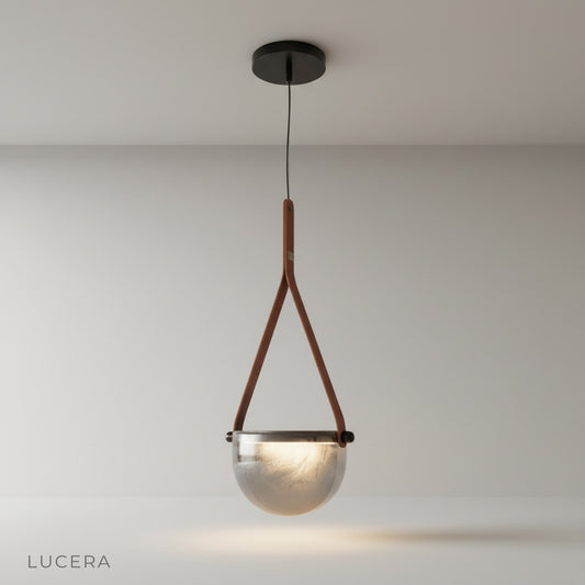 studio shot of Glimmer pendant light with transparent glass shade and metal base