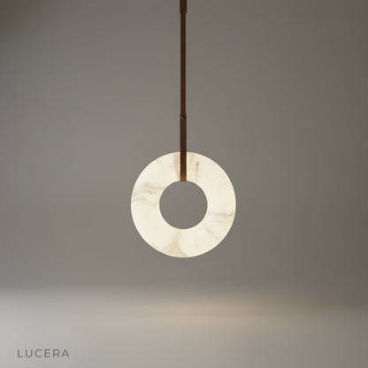 studio shot of Helix alabaster pendant light with leather straps on clean white background