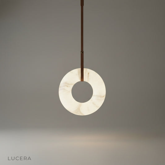 studio shot of Helix alabaster pendant light with leather straps on clean white background