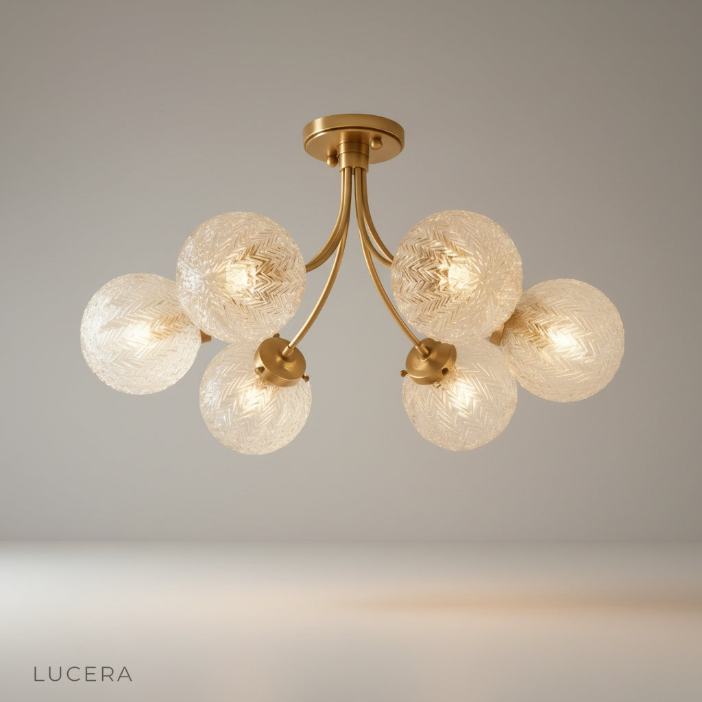 Studio shot of Glaucous ceiling light with chevron glass shades and brass finish