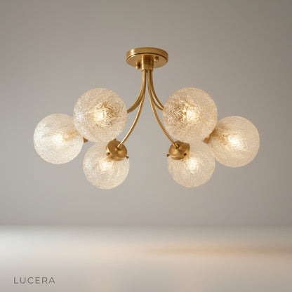 Studio shot of Glaucous ceiling light with chevron glass shades and brass finish