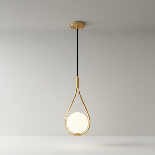 copper teardrop pendant light over modern dining table in warm interior
