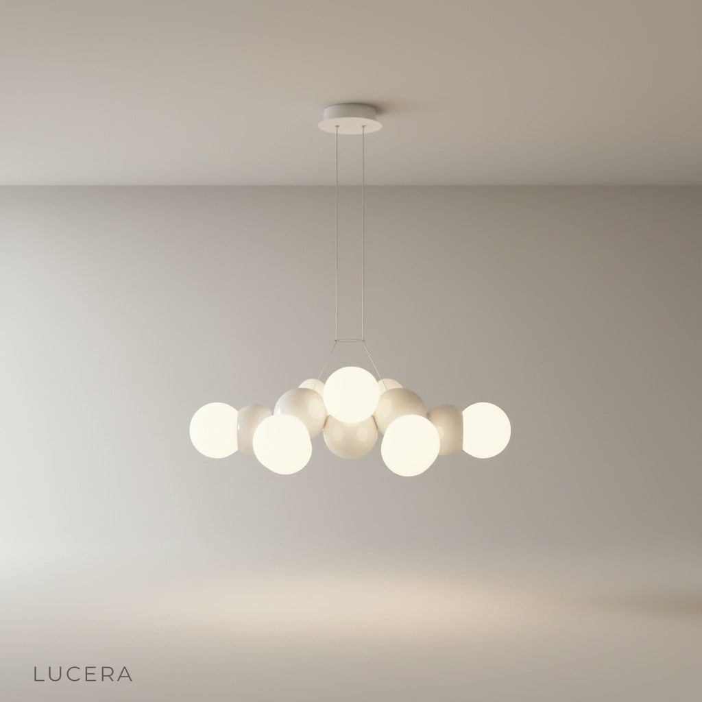 studio shot of Fascia pendant light with three frosted glass globes on iron mount