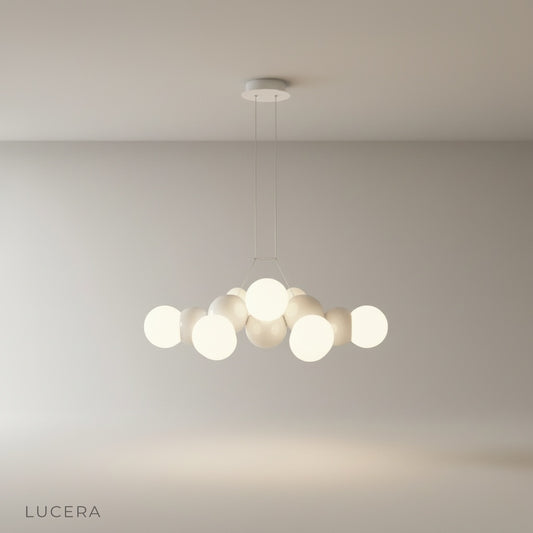 studio shot of Fascia pendant light with three frosted glass globes on iron mount