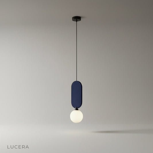 studio shot of Karat pendant lamp with spherical glass bulb and sleek metal frame