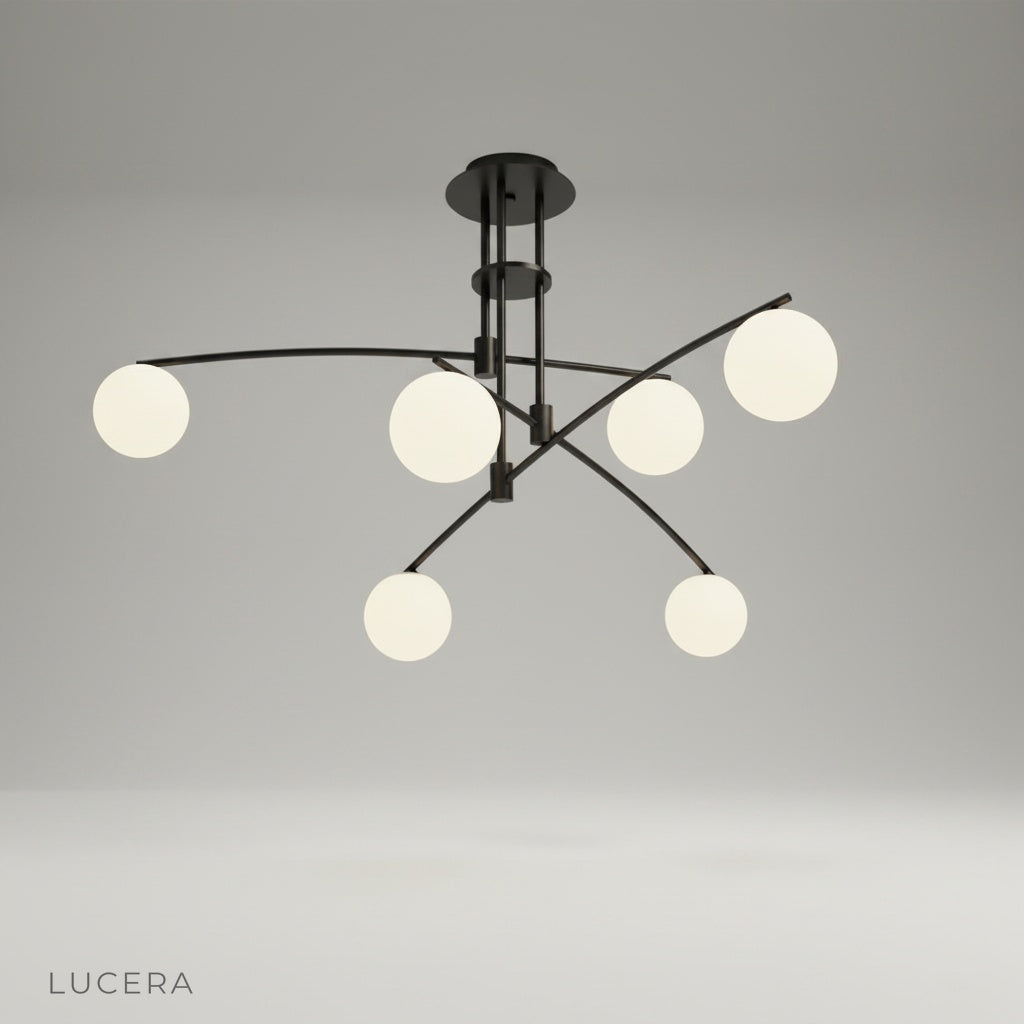 studio shot of Yonder ceiling lamp front view showing sculptural black iron frame and three frosted glass globes