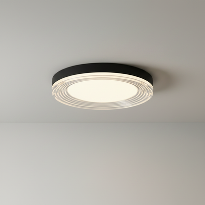 studio shot of round black ceiling light with layered acrylic rings front view