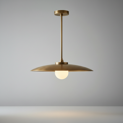 Studio shot of Sylvaine pendant light with wide brass shade and vertical stem