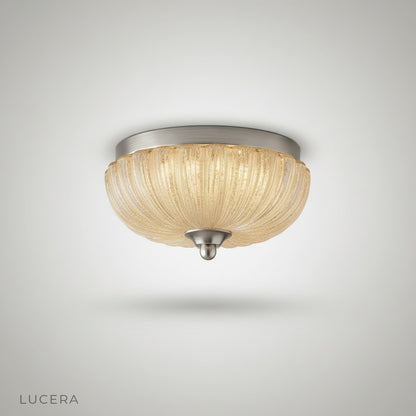 studio shot of Lucera ceiling light with clear glass shade and iron frame