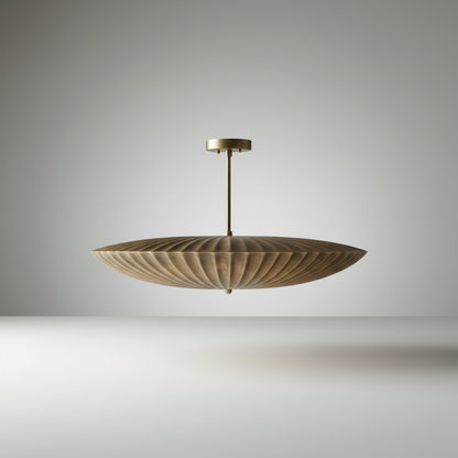 Studio shot of the Motion Pendant Light front view with fluted brass silhouette on white background