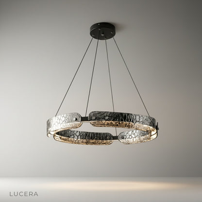 studio shot of pristine chandelier with segmented iron frame and clear glass