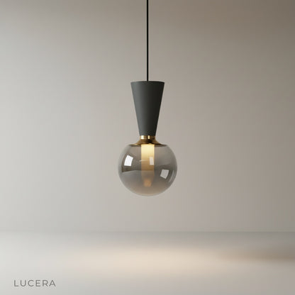 studio shot of Ivan pendant light with concrete cone and smoky glass orb