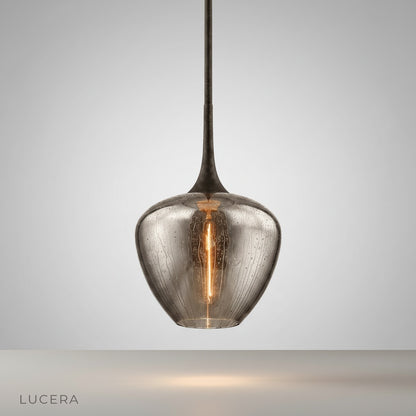 Studio shot of Livid Pendant Light with sleek iron frame and teardrop glass shade