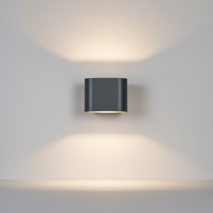 Spica Aeris wall sconce front view on clean white studio background showing textured black aluminum