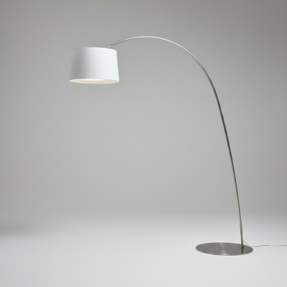 studio shot of Gabbro arc floor lamp with curved aluminum arm and round base
