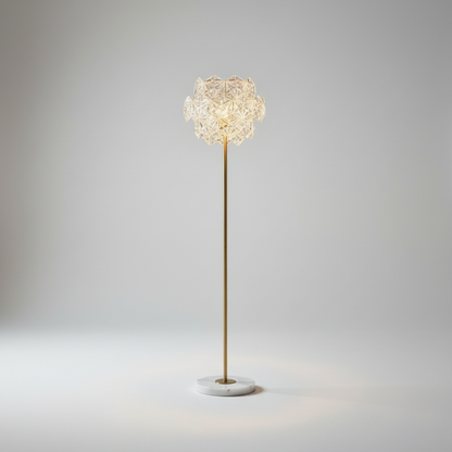 studio shot of floor lamp with white marble base and copper accents on neutral background