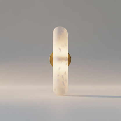 Studio shot of the Cosmo Alabaster vertical wall sconce with brass mount on a clean white background