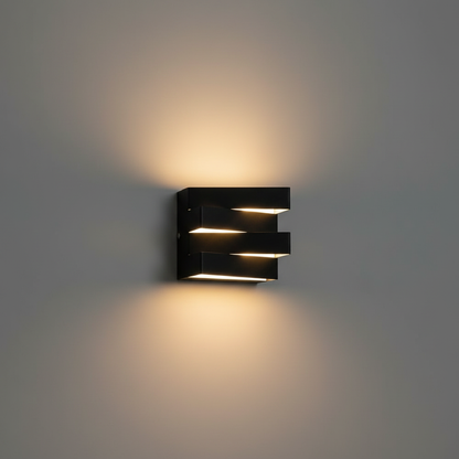 studio shot of sleek aluminum Heline wall light in warm 3000K glow