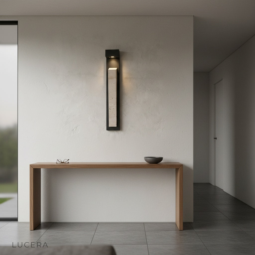 Close-up of travertine texture and warm light on Elisk wall lamp against white wall