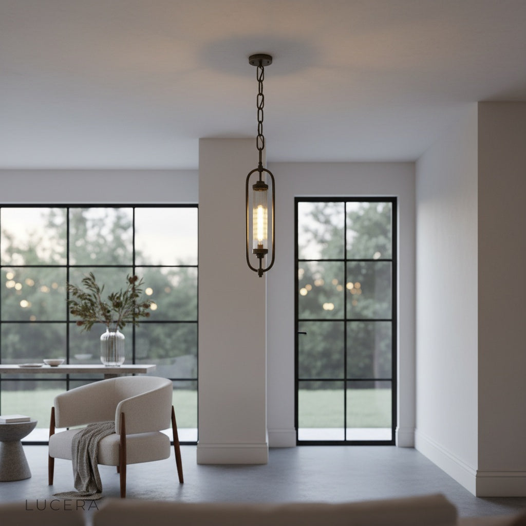 sculptural brass pendant lamp casting layered light patterns on neutral wall in hallway