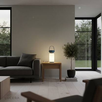 Portable table lamp casting soft evening glow on cozy balcony patio setting