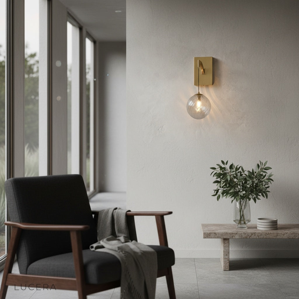 ionic wall sconce illuminated at dusk in contemporary hallway