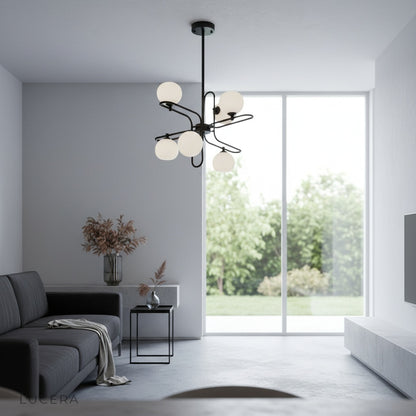 litany chandelier glowing at dusk in high-ceiling hallway