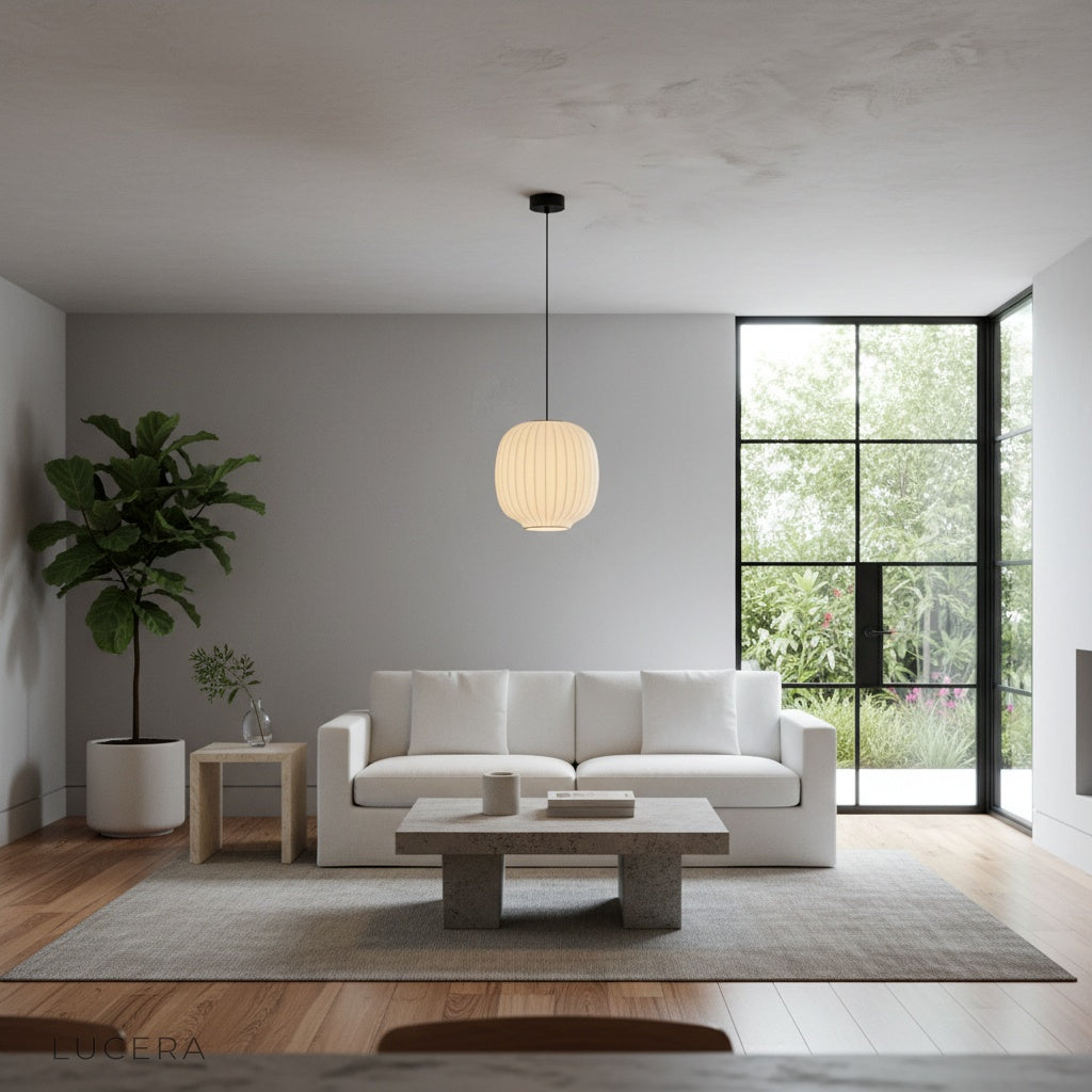 Quoin Pendant Light over a bedroom nightstand casting warm evening light