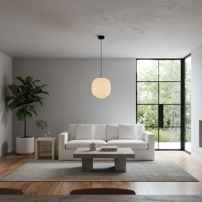 Quoin Pendant Light over a bedroom nightstand casting warm evening light