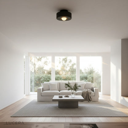 nighttime lifestyle shot of ceiling light casting warm pool of light in reading nook