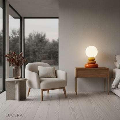 Lamp casting warm evening glow on cream armchair in stylish reading corner