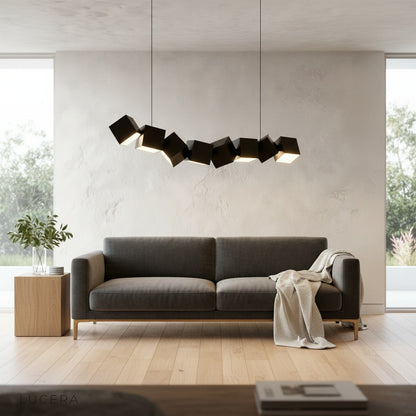 Ypsilon pendant light white variant hanging above dining table with warm ambient light