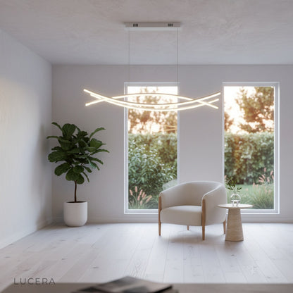 Eterno Chandelier suspended over reading nook with flexible form and warm LED light