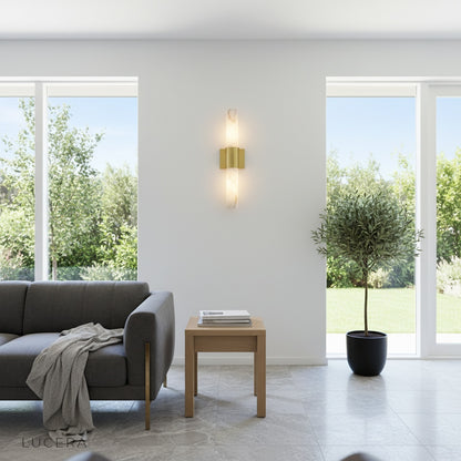 Umbra Alabaster wall sconce illuminating a cozy living room corner at dusk